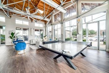 A large living room with a ping pong table